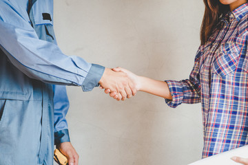 Engineering and worker with helmet handshake together to agree j