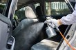 © Nattakorn - Close up hand of specialist cleaner wearing personal protective equipment PPE using chemical alcohol spray cleaning inside car to disinfect and decontaminate coronavirus covid-19