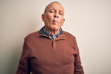 Canvas Print - Senior handsome man  wearing elegant sweater standing over isolated white background making fish face with lips, crazy and comical gesture. Funny expression.