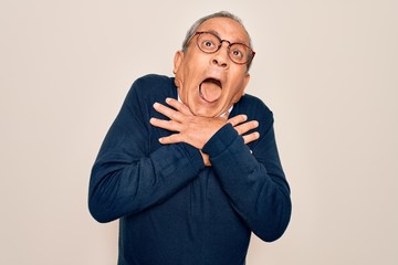 Canvas Print - Senior handsome grey-haired man wearing sweater and glasses over isolated white background shouting and suffocate because painful strangle. Health problem. Asphyxiate and suicide concept.