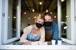 © Halfpoint - Coffee shop owners with face masks, lockdown, quarantine, coronavirus, back to normal concept.