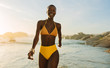 © Jacob Lund - Attractive african woman in bikini walking on the beach