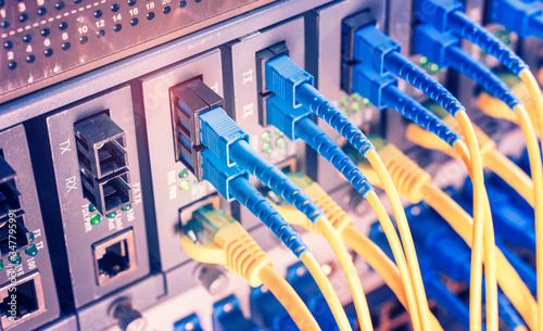 Photographie Fiber Optic cables connected to optic ports and UTP and Network cables connected