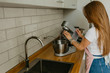 © Roman - Young Woman Cooking in the kitchen. Healthy Food. Dieting Concept. Healthy Lifestyle. Cooking At Home. Prepare Food