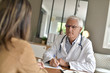 © goodluz - Doctor attending patient in office