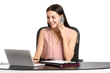 Wall Mural - Beautiful young secretary talking by phone at table on white background