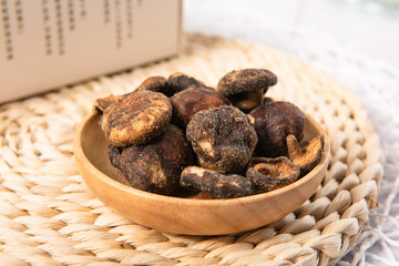 Wall Mural - Roasted dried shiitake mushrooms are served on a plate.