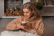 © Pixel-Shot - Beautiful young woman drinking hot chocolate at home