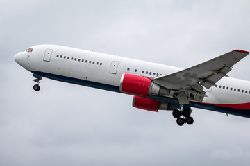 Modern wide-body passenger airplane flies in the air