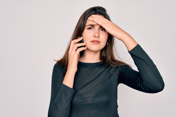 Canvas Print - Young beautiful woman having a conversation talking on smartphone ove isolated background stressed with hand on head, shocked with shame and surprise face, angry and frustrated. Fear and upset