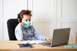 © wip-studio - Distance learning online education. schoolboy in medical mask studying at home, working at laptop notebook and doing school homework. coronavirus quarantine