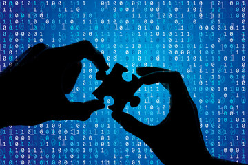 Sticker - Silhouette of a hands holding a jigsaw puzzle piece with binary background