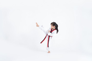 Asian kid Taekwondo kicking in white studio