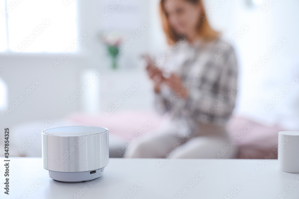 Smart home assistant device on table in bedroom