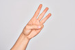 © Krakenimages.com - Hand of caucasian young man showing fingers over isolated white background counting number 3 showing three fingers