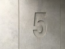 Number 5 On Concrete Wall