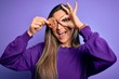 © Krakenimages.com - Young beautiful brunette woman holding healthy chocolate cookie over eye with happy face smiling doing ok sign with hand on eye looking through fingers