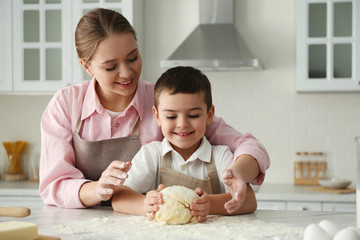 Poster - Mother and son cooking together in kitchen