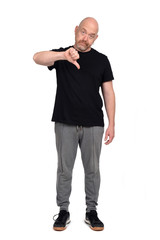 man with sportswear thumb down  on white background