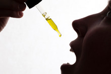Silhouette Of A Woman Taking Drops Of CDB Oil