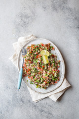 Wall Mural - Quinoa Quinua salad with tomatoes and herbs in white bowl