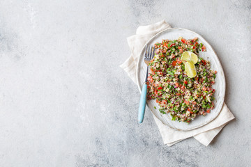 Wall Mural - Quinoa Quinua salad with tomatoes and herbs in white bowl