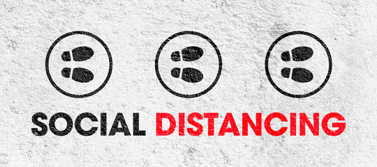 Concept of social distancing - Marking on the ground of circles with footprints on a textured background of bitumen - Minimum distance between people - Covid-19 coronavirus crisis