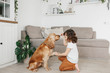 © sweetlaniko - Cute little girl with dog at home