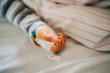 © Cavan Images - Baby child hand with IV sick at the hospital with a virus coronavirus