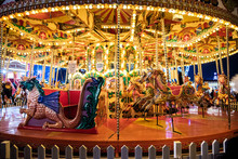 Illuminated Bright Carousel In Amusement Park
