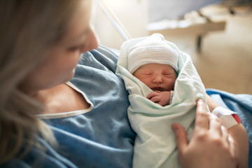 mother with her newborn baby at the hospital a day after a natural birth labor