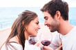 © Jordi Janau/ADDICTIVE STOCK - cheerful young couple in casual wear toasting with glasses of red wine while enjoying happy moments together