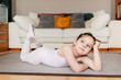 © Manuel Ruiz Alba/ADDICTIVE STOCK - Bored thoughtful little girl in leotard lying on the floor looking away while resting during ballet rehearsal at home