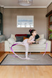 © Manuel Ruiz Alba/ADDICTIVE STOCK - Cute little girl in leotard and tights spinning ribbon and dancing during rhythmic gymnastic training in cozy living room at home