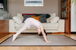 © Manuel Ruiz Alba/ADDICTIVE STOCK - Side view of little girl in leotard doing exercise on floor during dance rehearsal at home