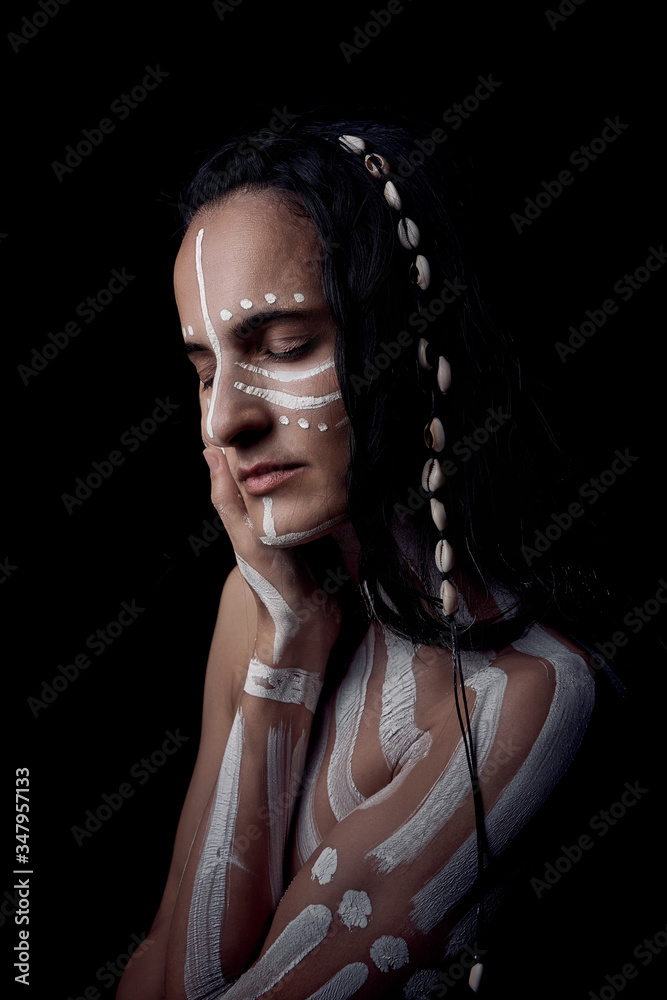 Side view portrait of naked tender beautiful brunette Native American woman with white striped