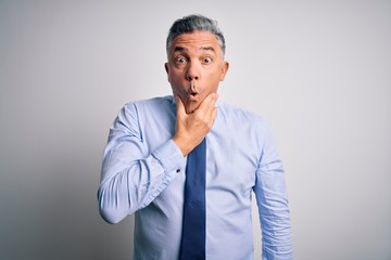 Poster - Middle age handsome grey-haired business man wearing elegant shirt and tie Looking fascinated with disbelief, surprise and amazed expression with hands on chin