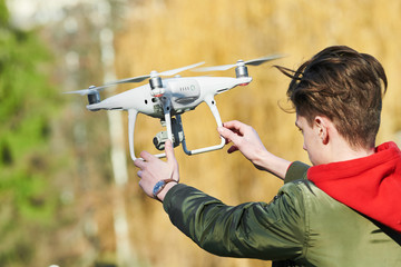 Wall Mural - drone flying. young man with copter outdoors