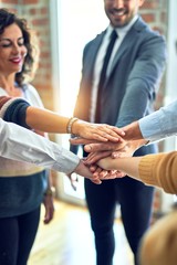 Group of business workers standing with hands together at the office