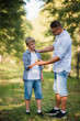 © romankosolapov - Father and son in the park or forest for a walk
