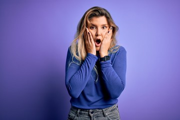 Poster - Young beautiful blonde woman wearing casual t-shirt over isolated purple background afraid and shocked, surprise and amazed expression with hands on face