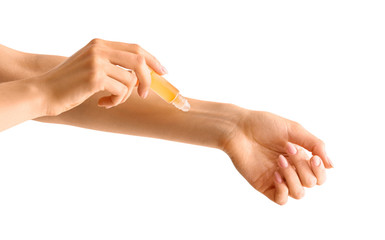 Wall Mural - Woman applying roll-on perfume onto her hand against white background