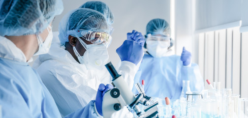 Wall Mural - africam american biological research scientist and team working together in vaccine development labo