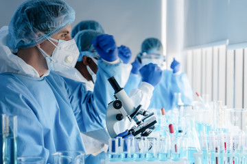 Wall Mural - caucasian biological research scientist and team working together in vaccine development laboratory 