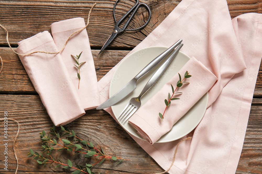 Beautiful table setting with floral decor on wooden background