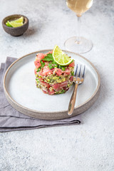 Wall Mural - Tuna tartare tartar with avocado and quinoa. gourmet presentation with culinary ring on wite plate