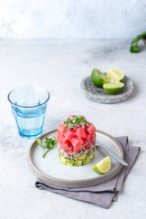 Wall Mural - Tuna tartare tartar with avocado and quinoa. gourmet presentation with culinary ring on wite plate