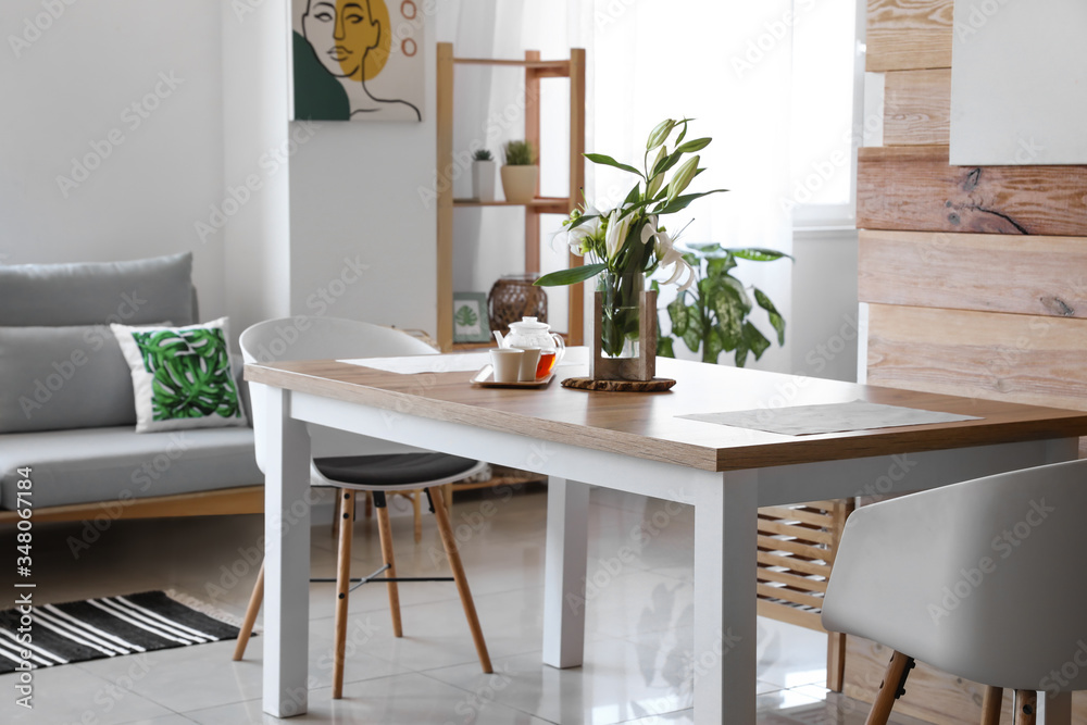 Interior of modern stylish dining room with floral decor
