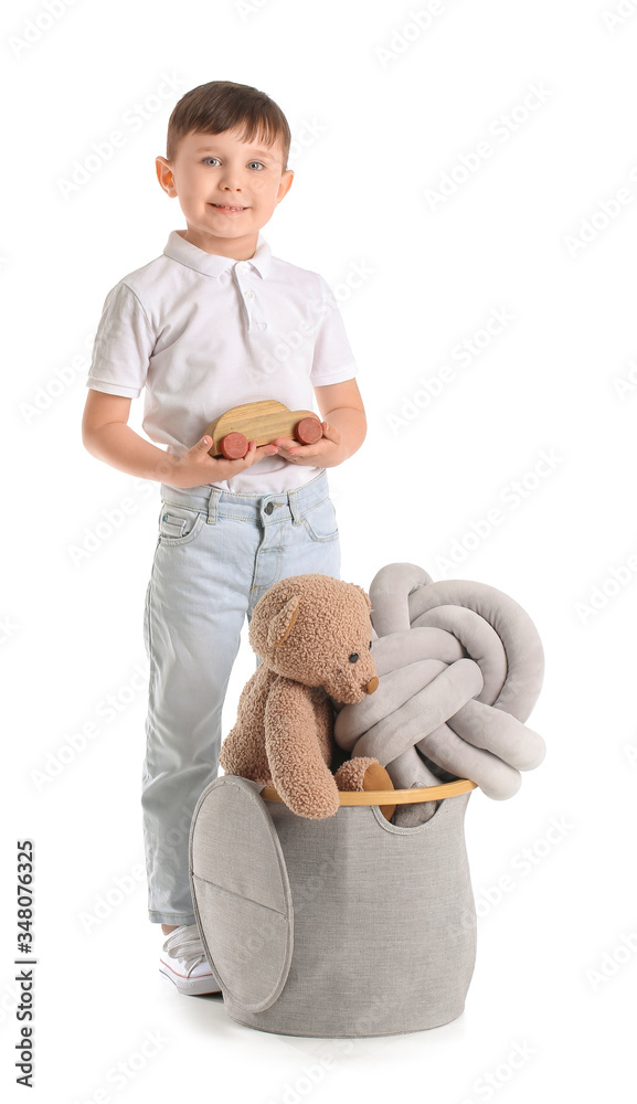 Little boy with toys on white background