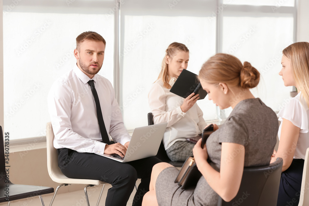 Business people waiting in line indoors